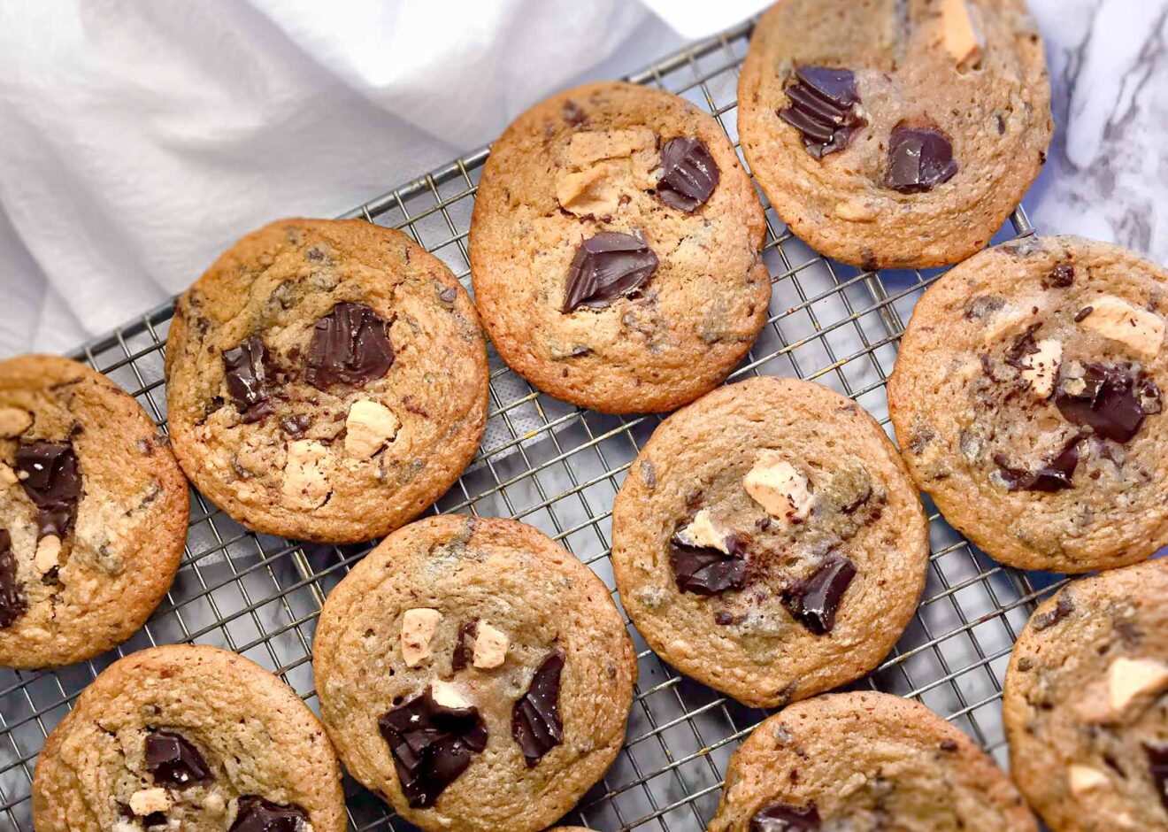 A cooling rack lined with double-chocolate, peanut butter Chip cookies.