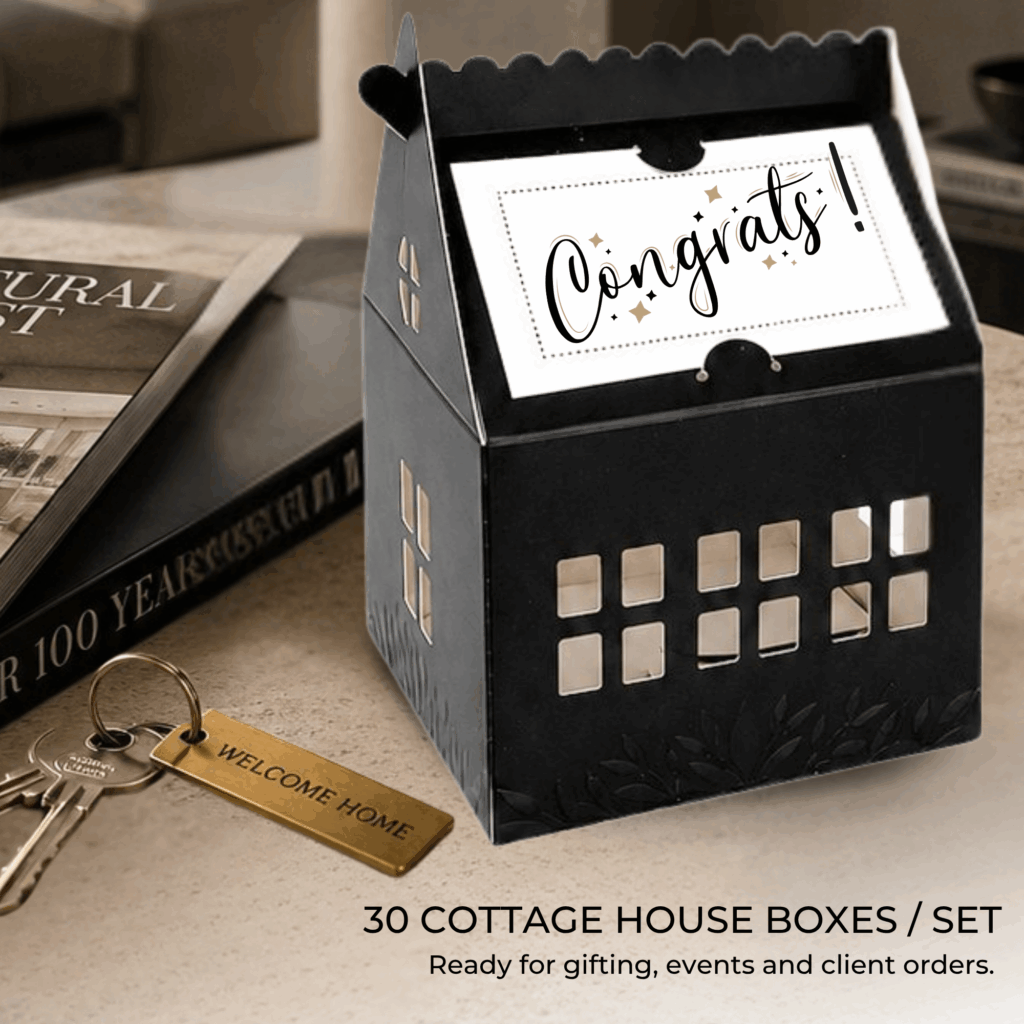 Black Cottage Boxes on realtor desk with house keys.